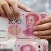 A clerk counts cash at a bank in Nantong, Jiangsu province