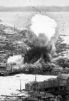 Para-demolition bombs being dropped on supply warehouses and dock facilities at a port in Wonsan, North Korea by the Fifth Air Force's B-26 Invader light bombers (ca. 1951)