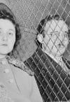 Julius and Ethel Rosenberg, separated by heavy wire screen as they leave U.S. Court House after being found guilty by jury